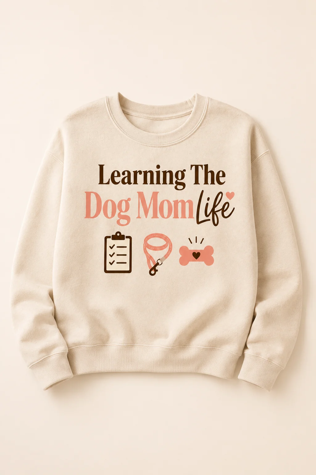 Learning The Dog Mom Life sweatshirt shown straight on in a clean minimal product setup without additional props