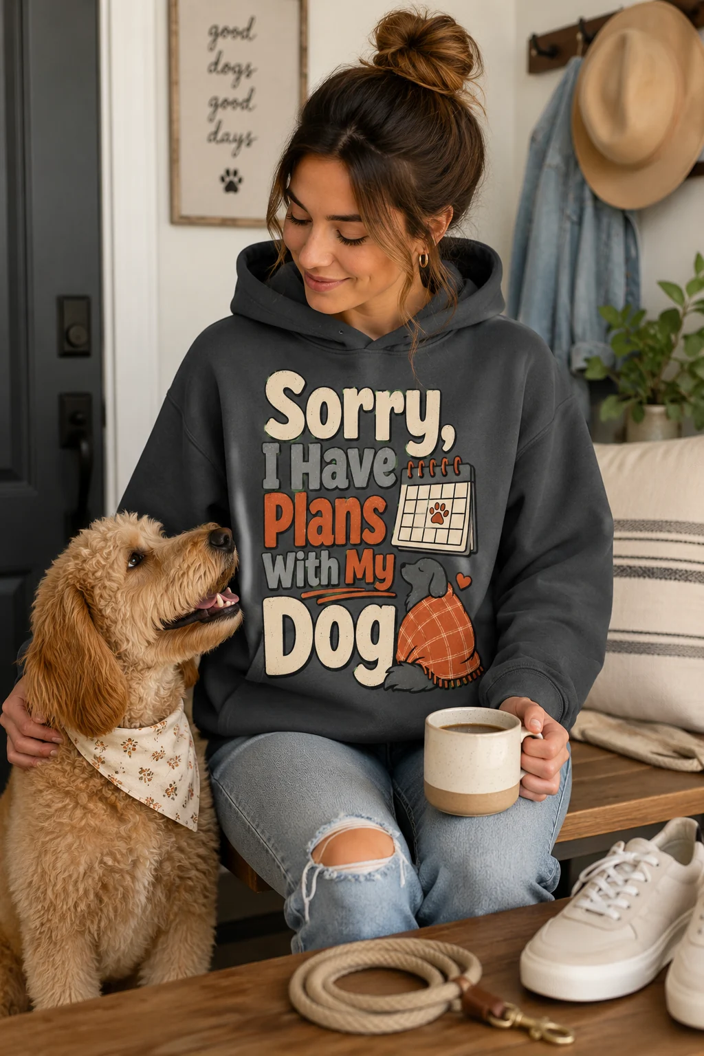 Dog mom hoodie styled in a casual lifestyle scene with a coiled leash, coffee cup, neutral sneakers, and denim
